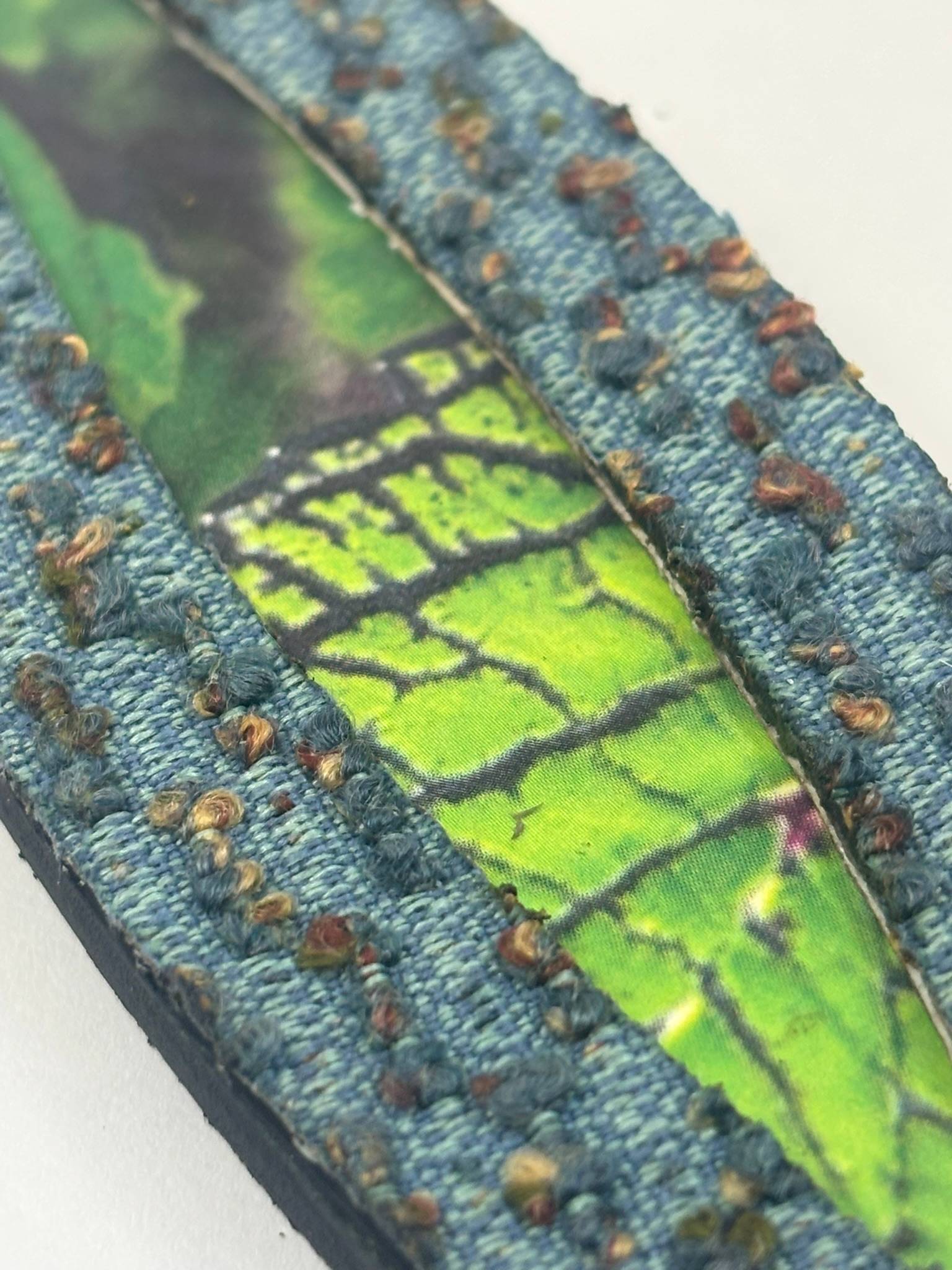 Weave of Life encaustic panel with reclaimed blue carpet tile border and vivid green crackled leaf photo interior. Nancy Fritz.