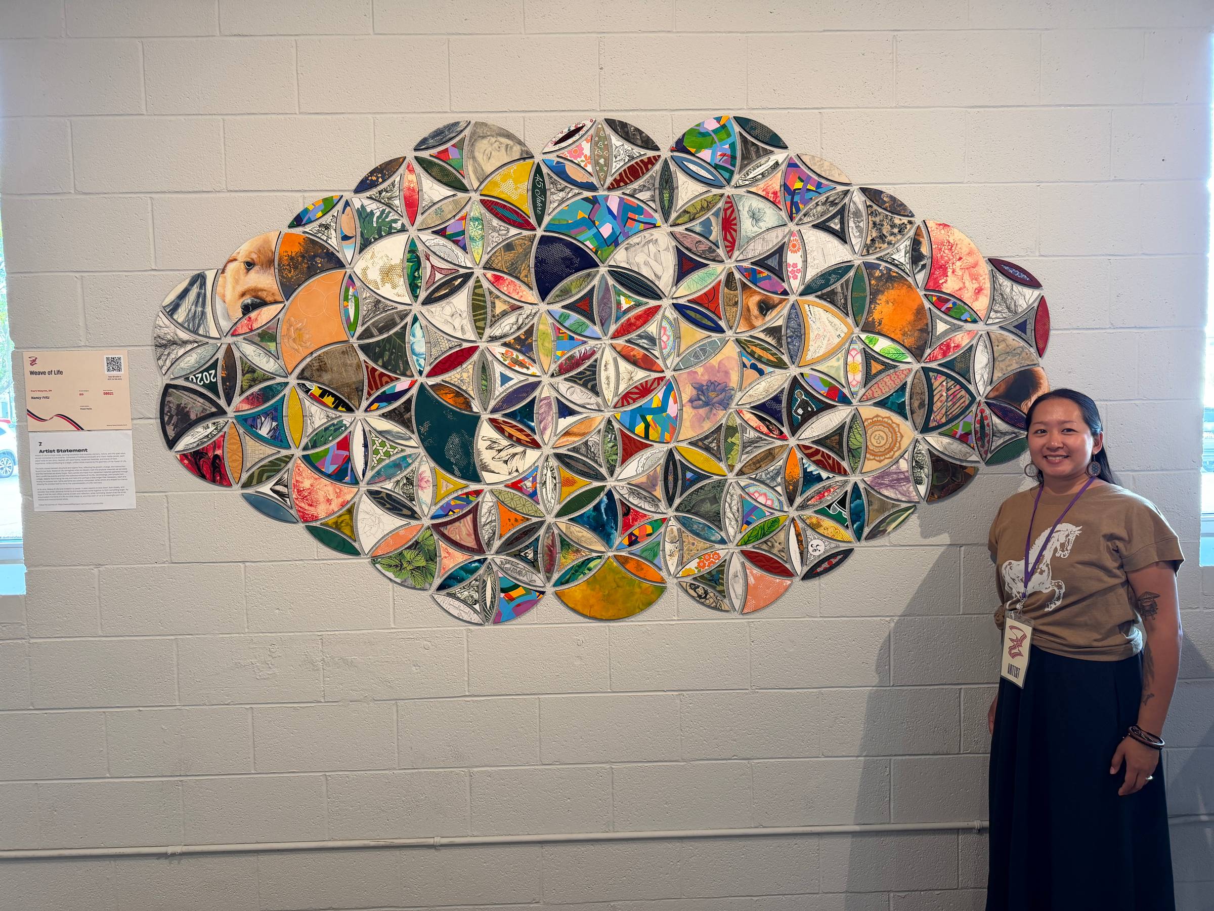 Nancy Fritz beside the completed Weave of Life installation at ArtPrize 2026, Monroe Community Church, Grand Rapids, Michigan.