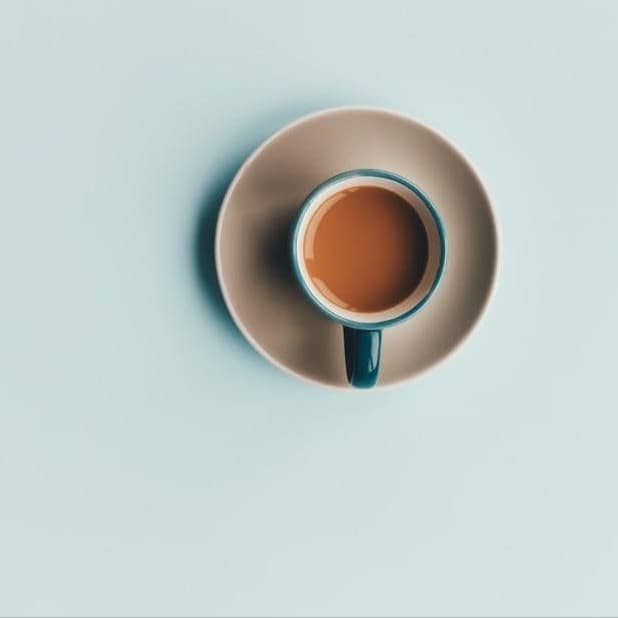 blue ceramic coffee cup and white saucer