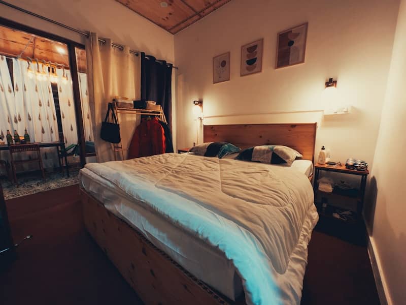 Cozy bedroom with a large bed and bedside table.