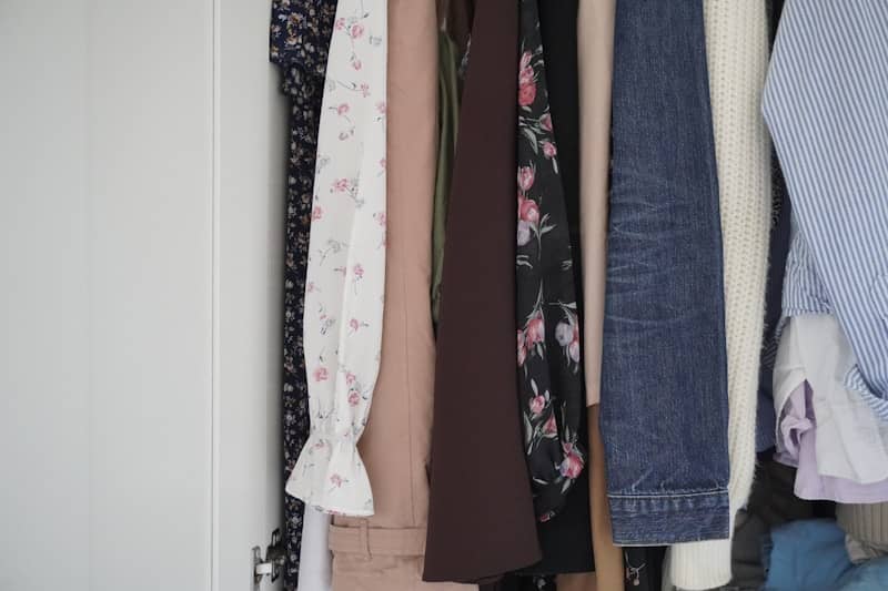 Assortment of clothes hanging in a closet