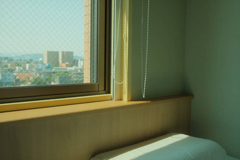 A window offers a view of the city.