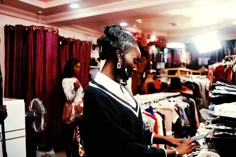 Woman in a clothing store with racks of clothes