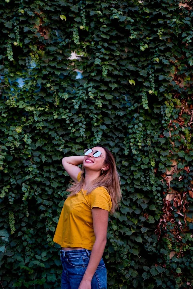 woman wearing orange shirt and blue denim bottoms
