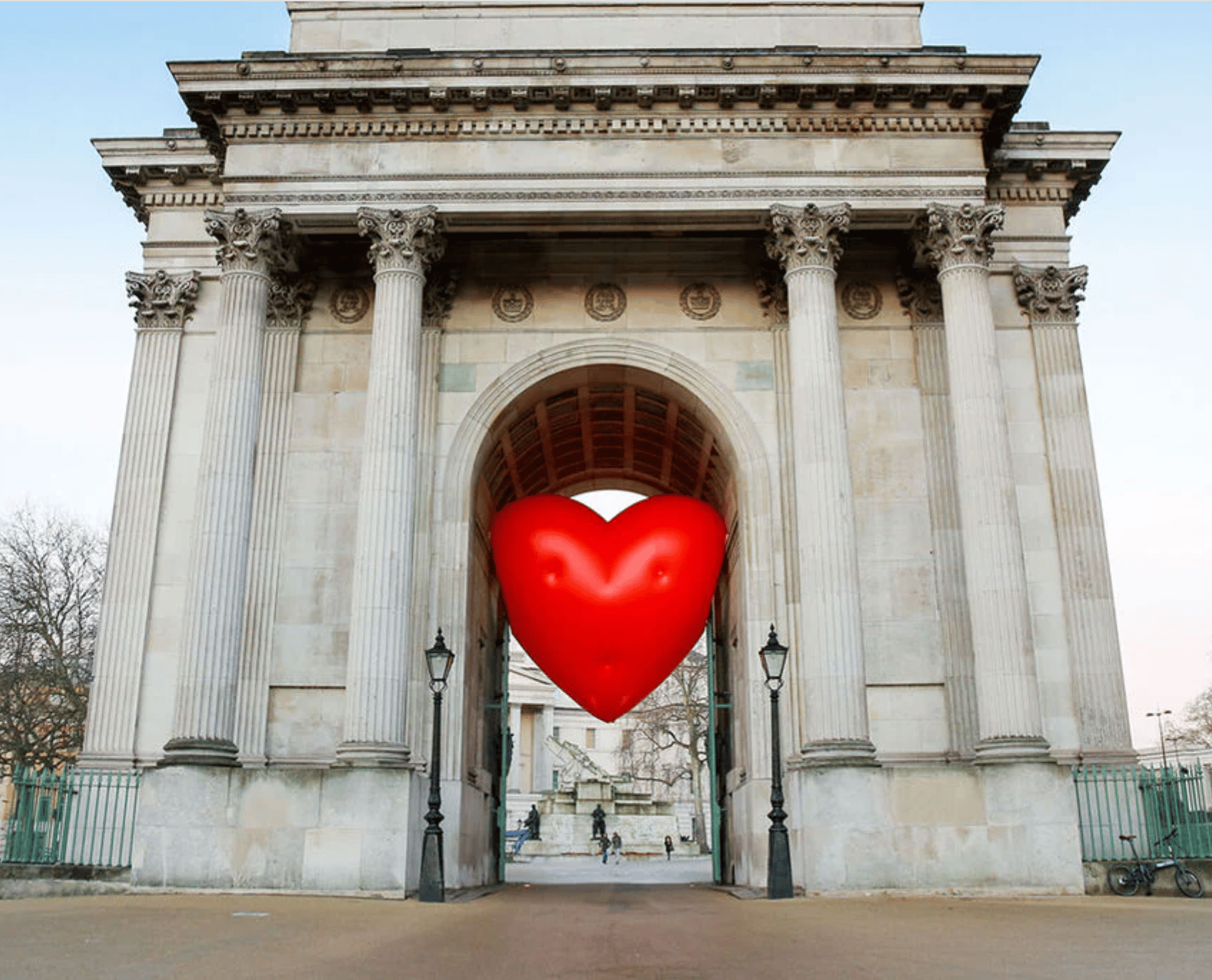Giant red chubby heart inside Wellington arch in London.