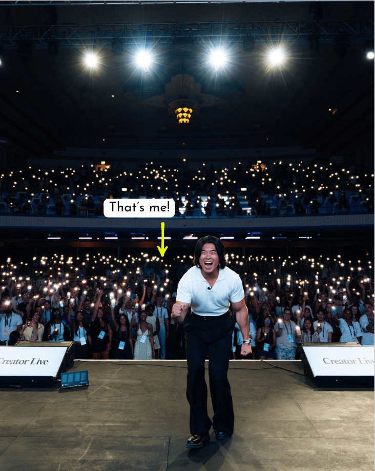 person standing on stage with 1000s of people in the audience behind him
