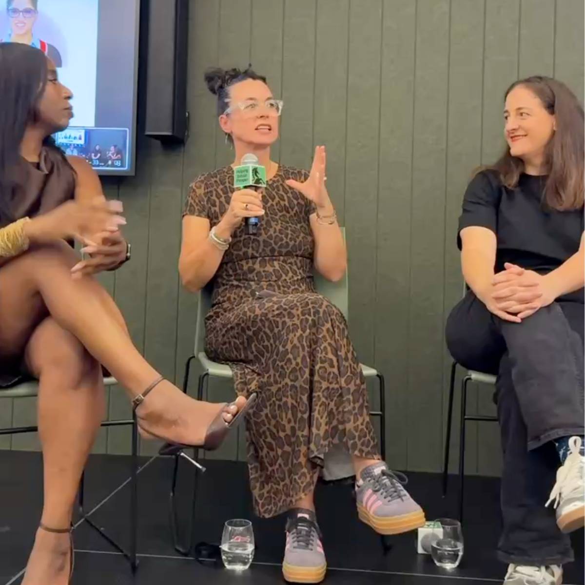 3 women talking on a stage