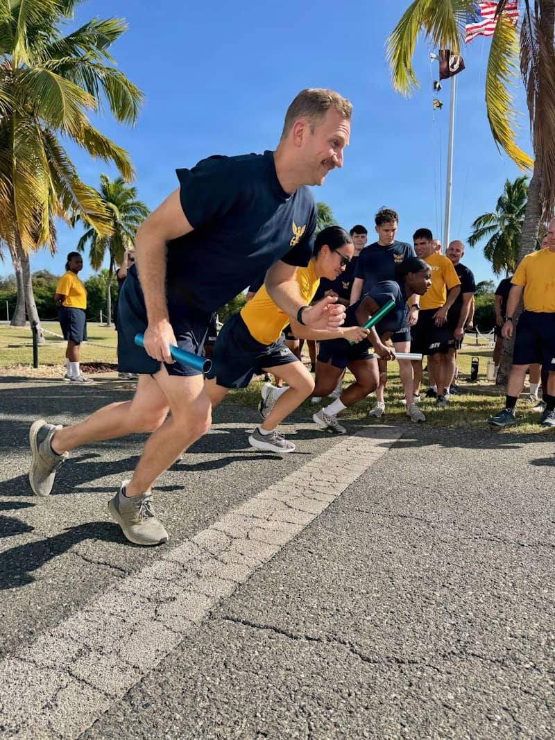 Sailors participate in a relay race outdoors