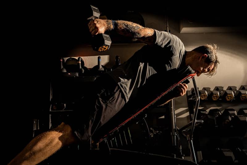 Man is working out with weights at the gym.