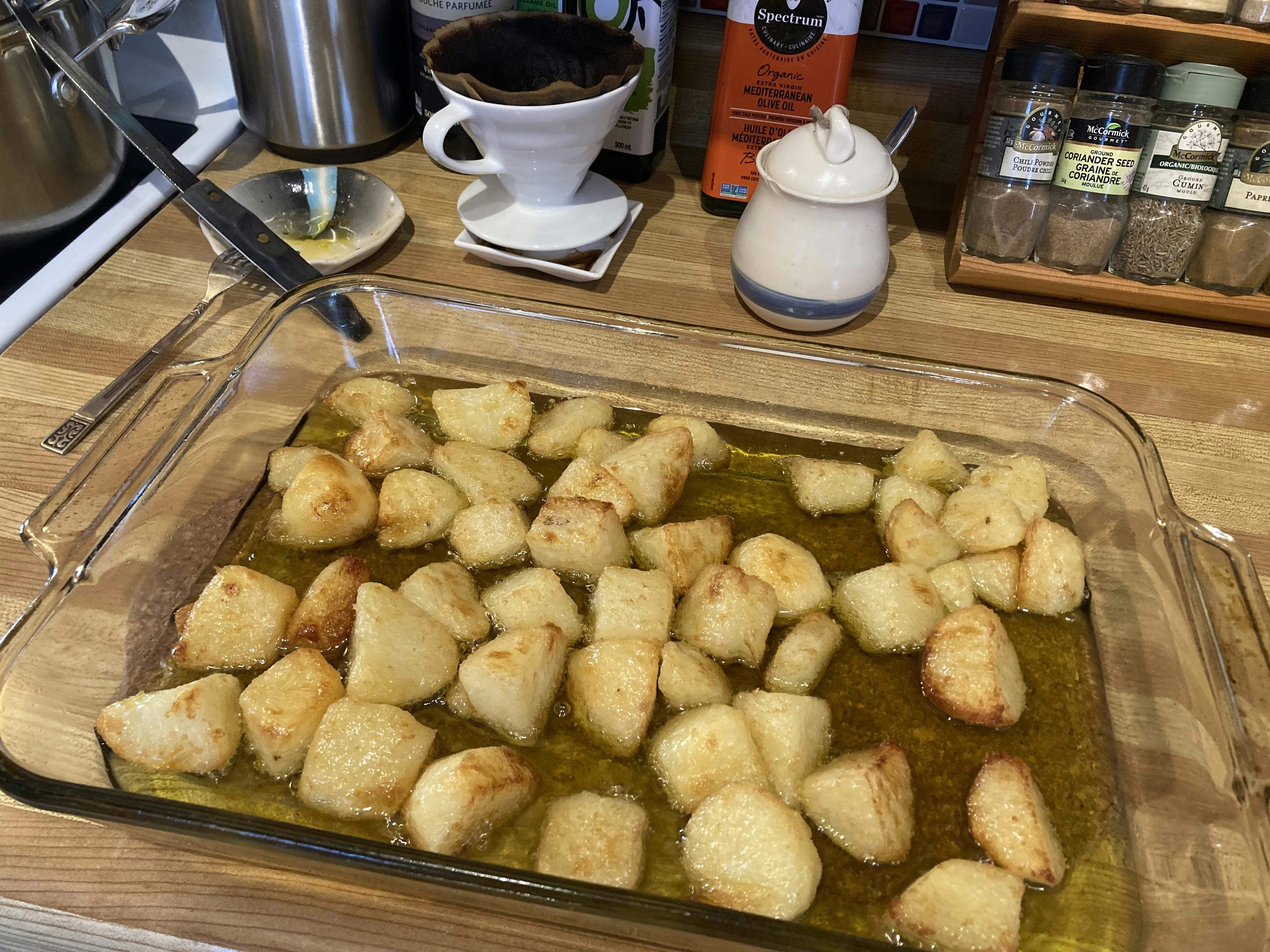 A pan of delicious-looking, crispy roast potatoes.