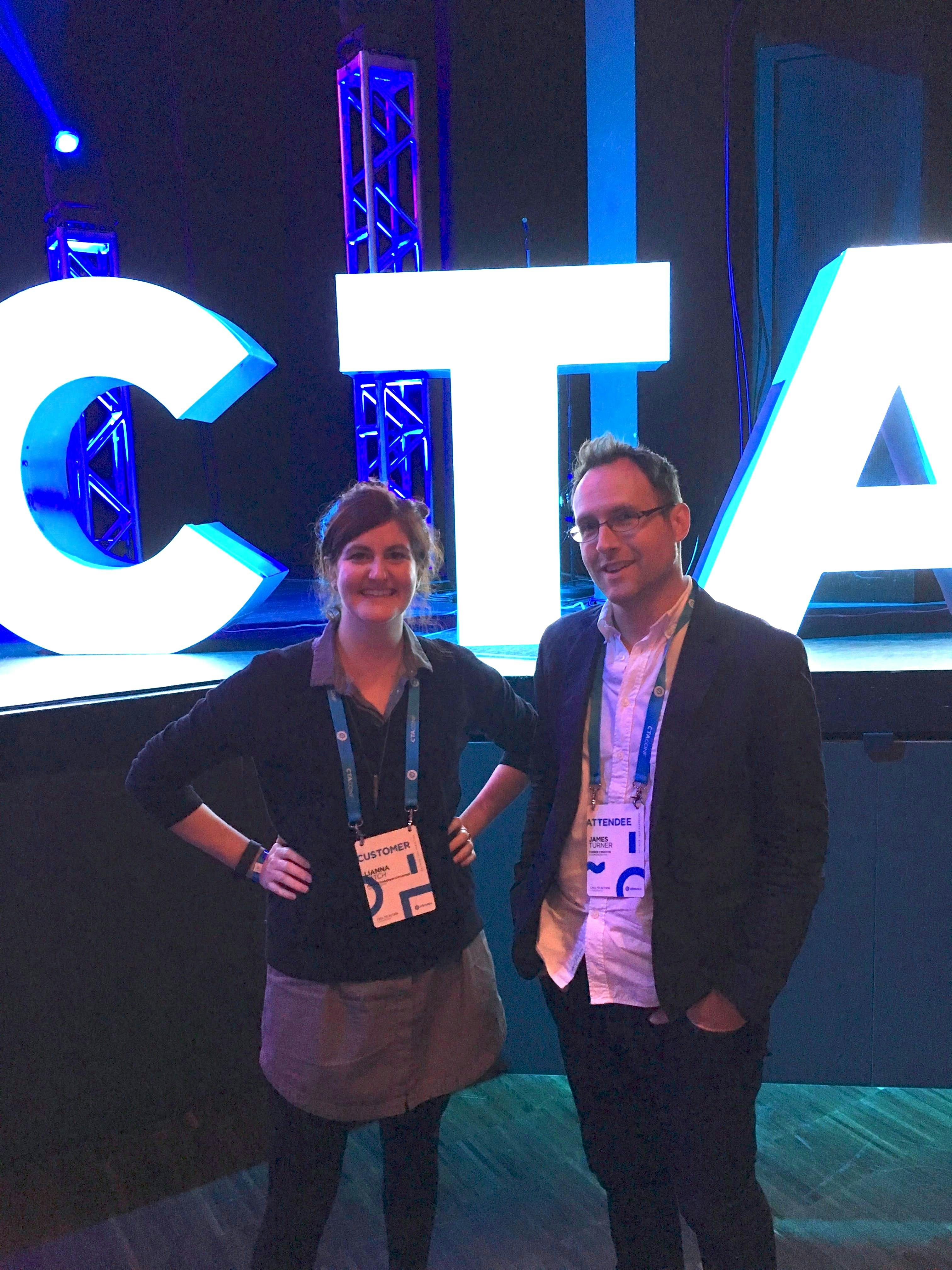 A photo of Lianna Patch and James Turner standing in front of the letters CTA in white