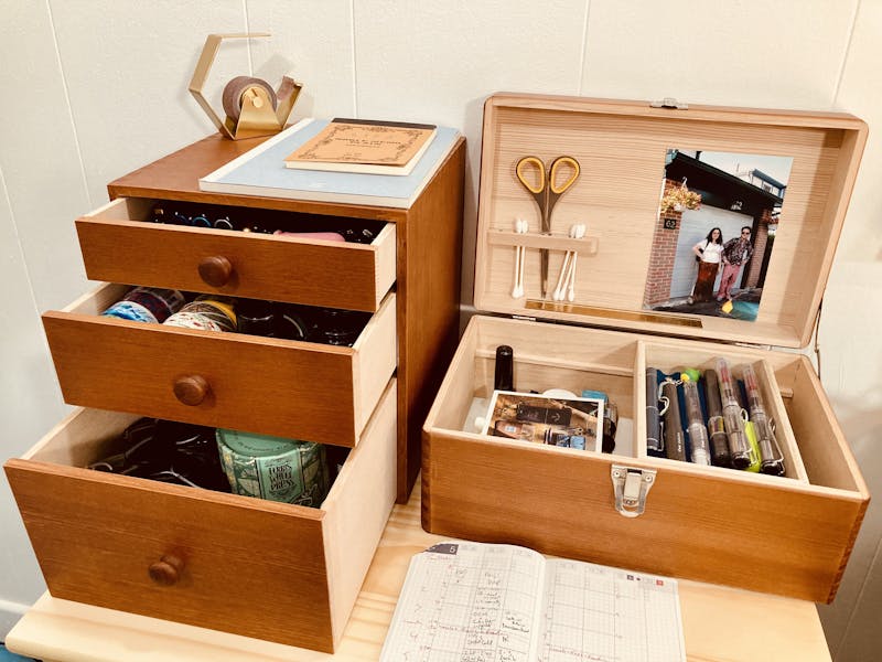 A photo of two wooden organizer boxes, open