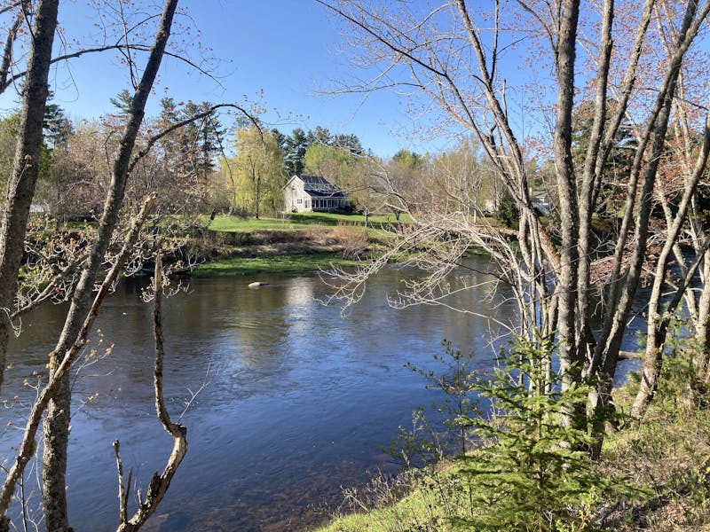 A picture looking across the river at a house