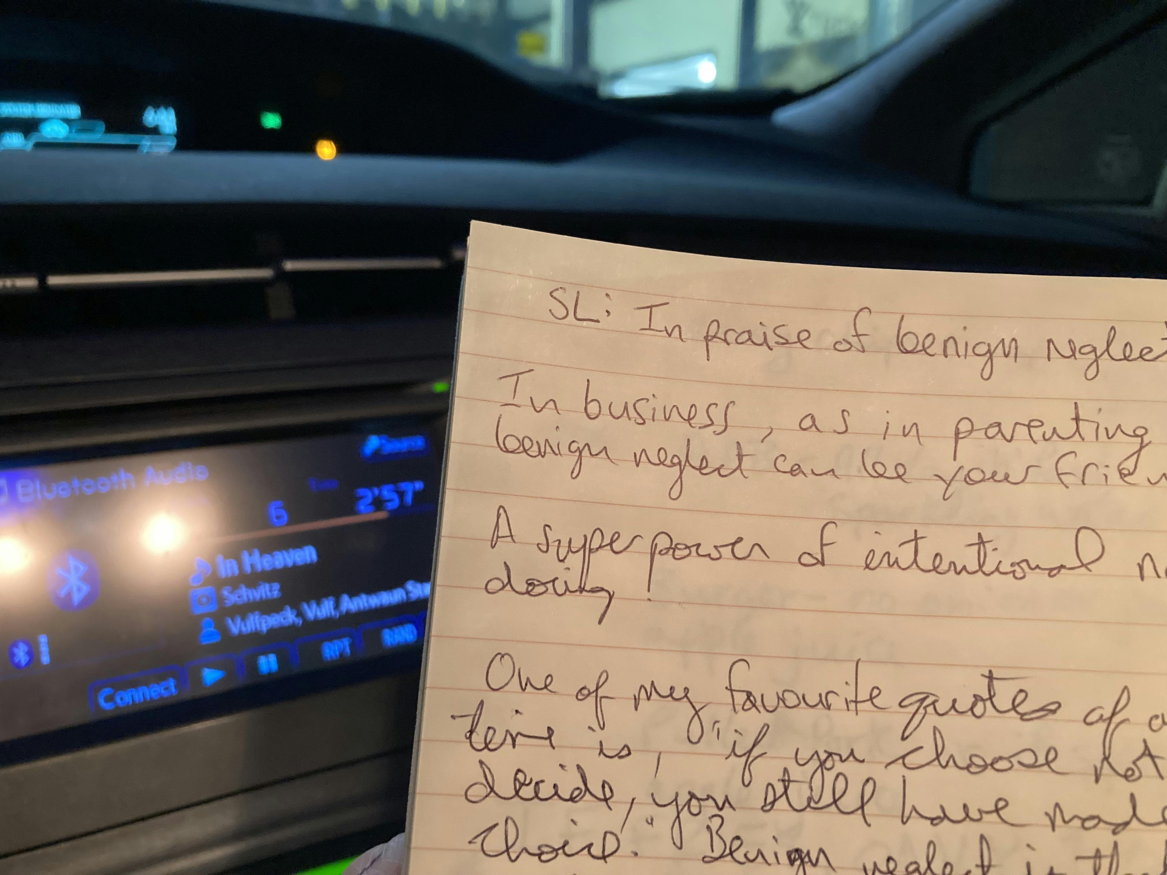 A photo of this blog post, written in a notebook, with the dashboard of a car visible in the background and Vulfpeck playing on the stereo