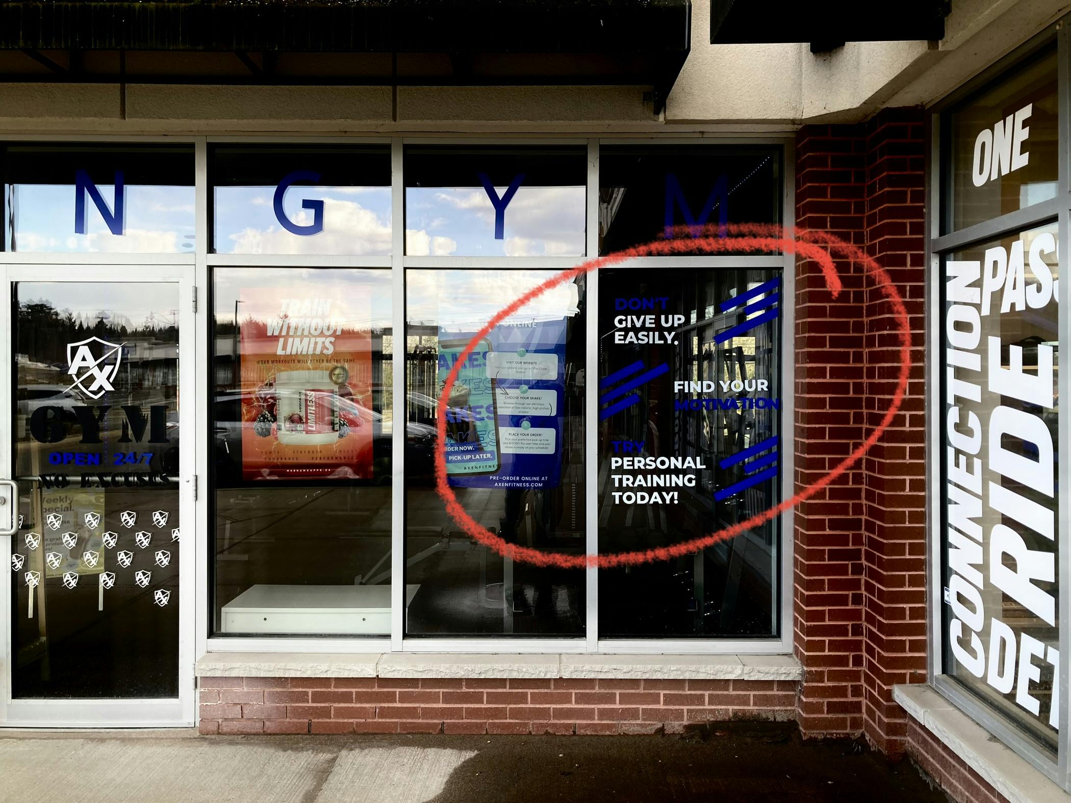 An image of a gym storefront, with some unfortunate light and dark lettering combos that make it seem as though they're saying "give up easily," when in fact you can't see the word "don't" at the very top.