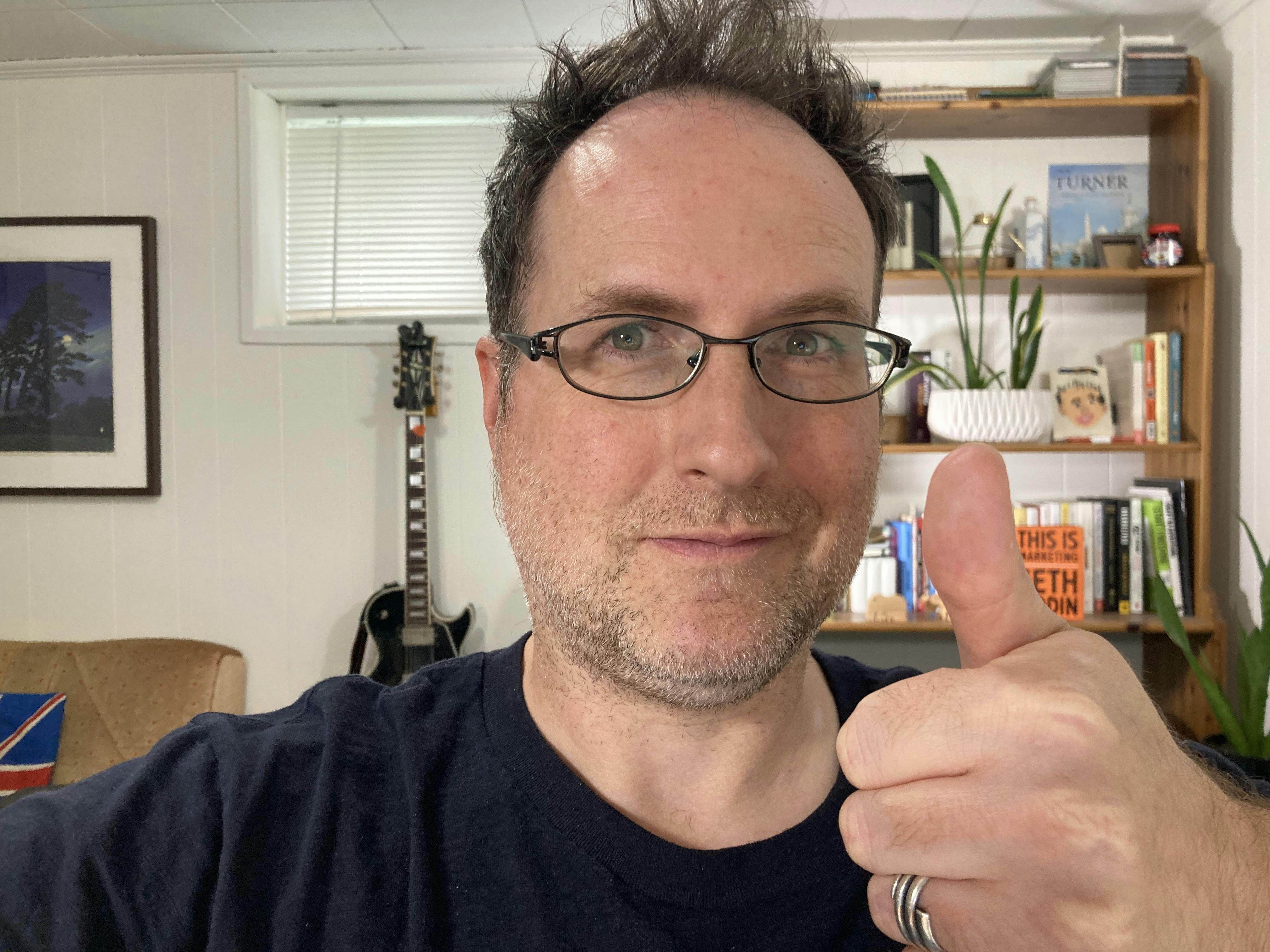 A photo of a 40-something dad endorsing his own cheesy saying with a thumbs-up