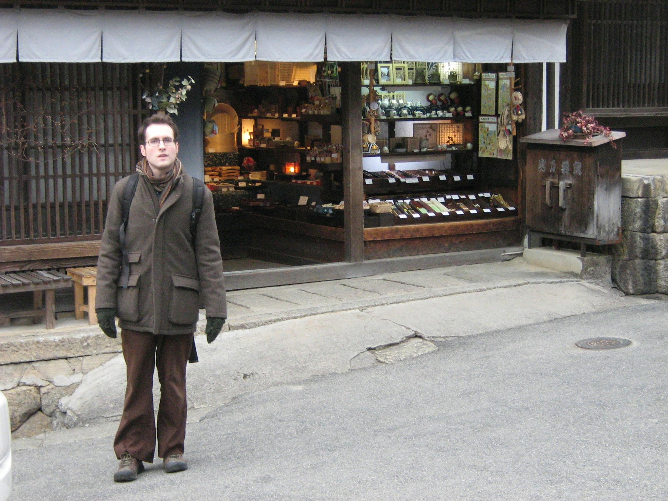 A photo of James Turner outside a very traditional-looking shop in Tsumago, Japan.