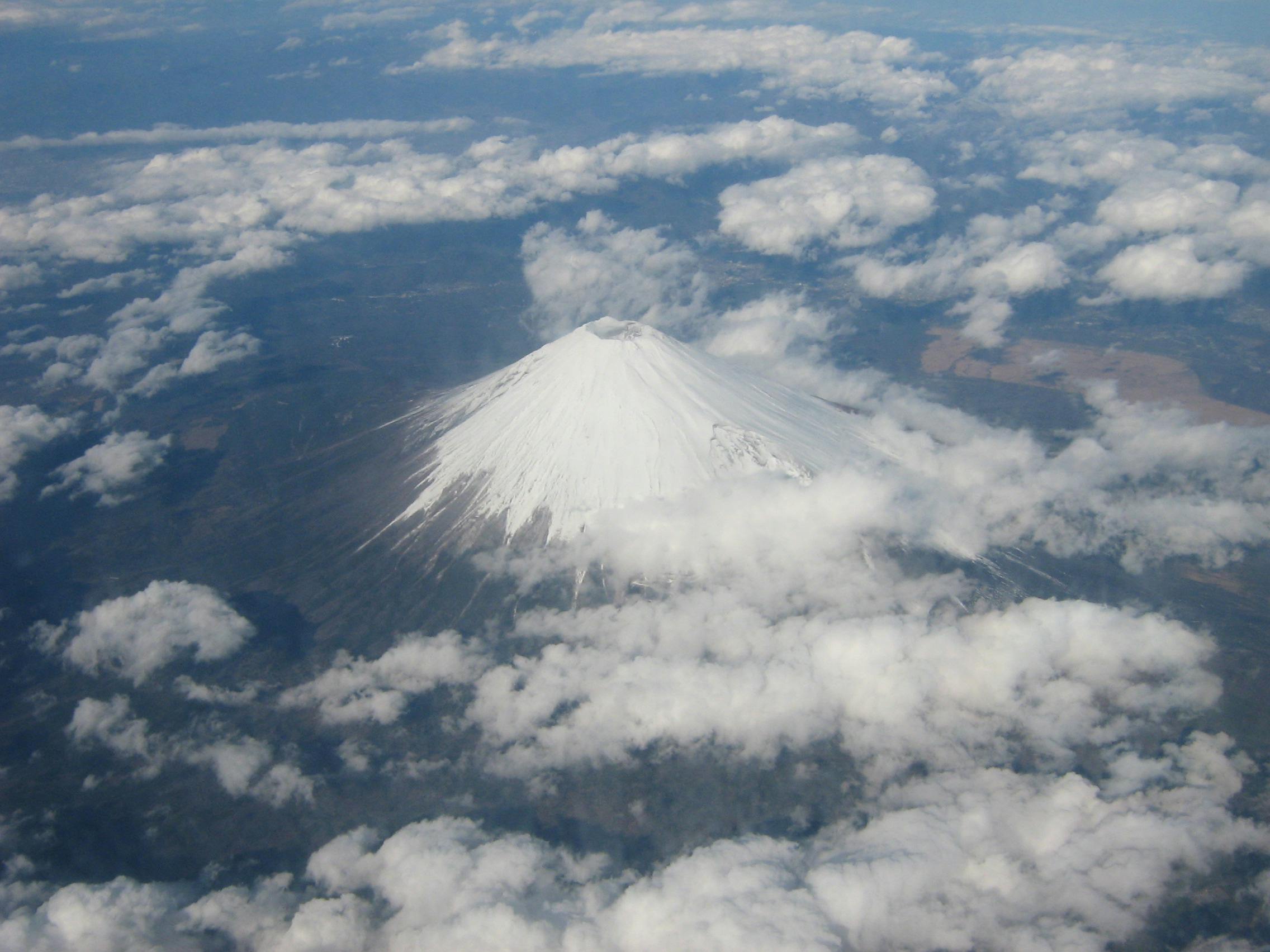 A photo of Mt. Fuji covered in snow, taken from an airplane.