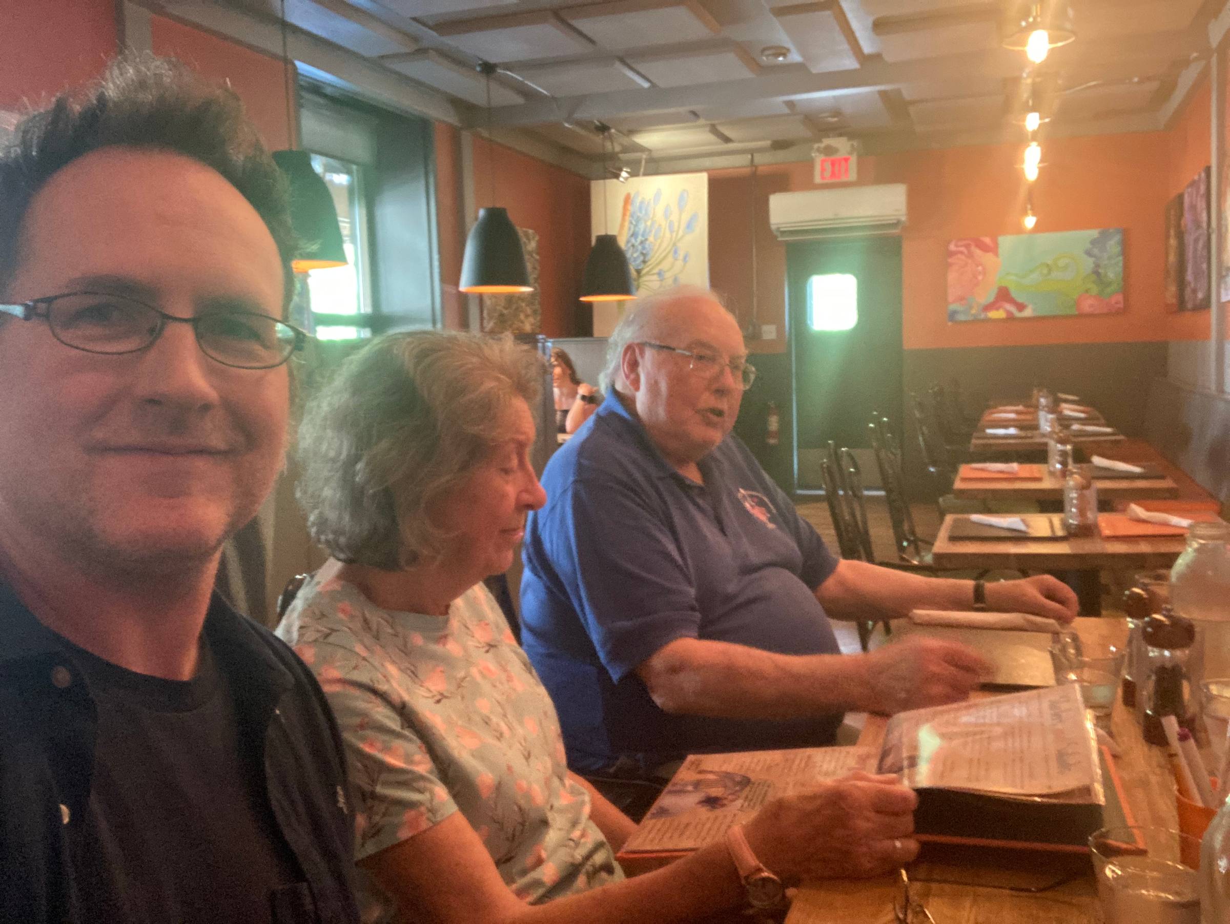 A selfie of me, my mum, and my dad, sitting at a restaurant table