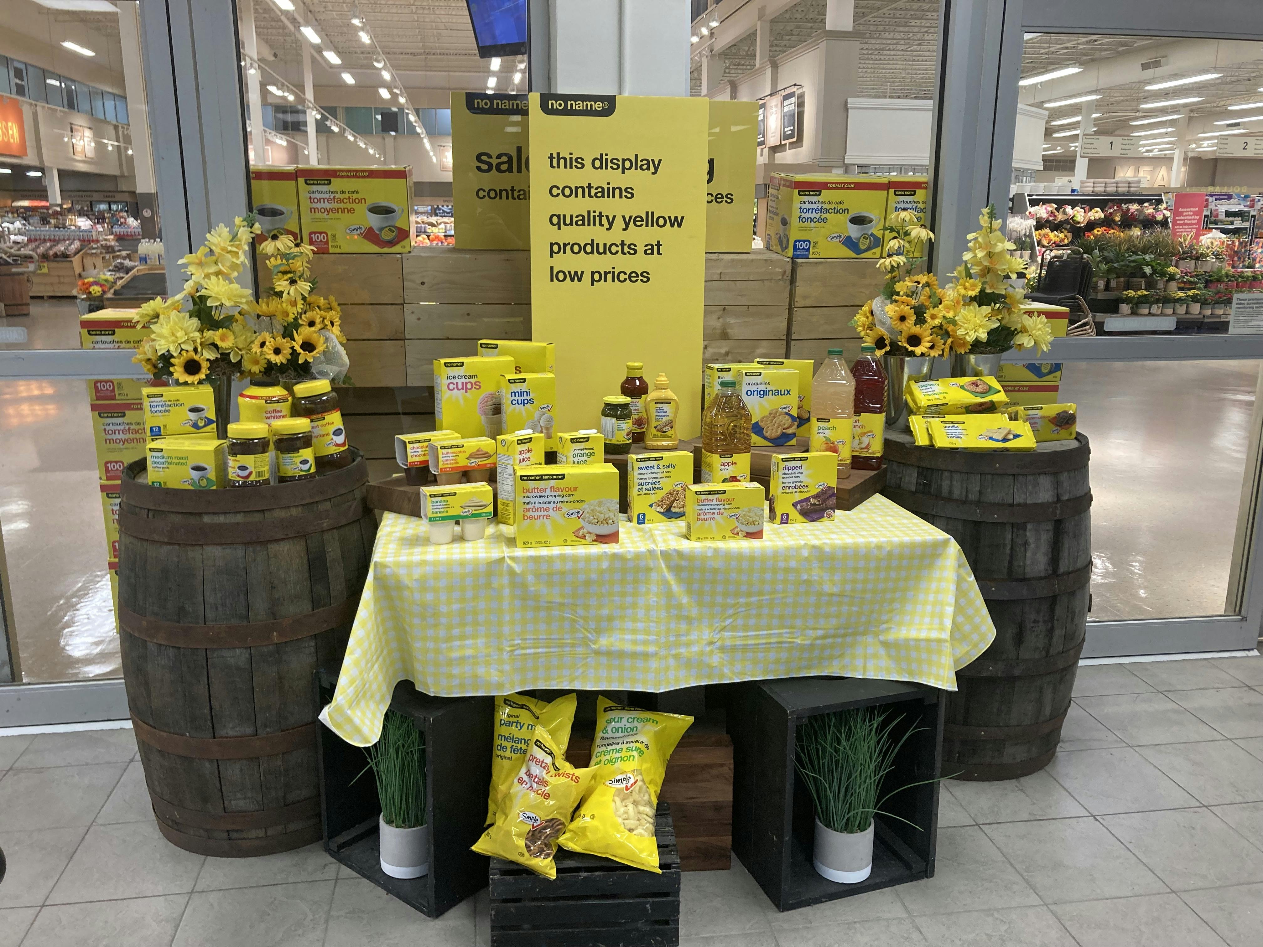 A photo of a display at the front of a local Atlantic Superstore grocery store, exhibiting the house brand "no name" which has all yellow packaging and is cheap.