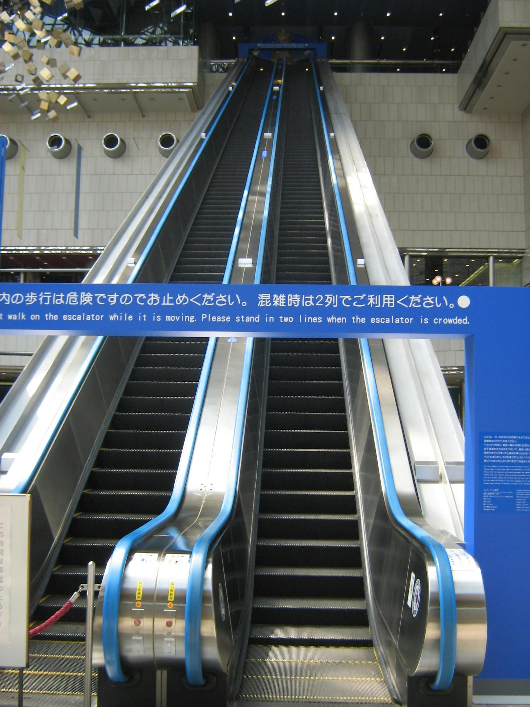 A photo of an escalator that spans 5 floors and is currently out of order, meaning users would have to walk up or down the entire thing to use it.