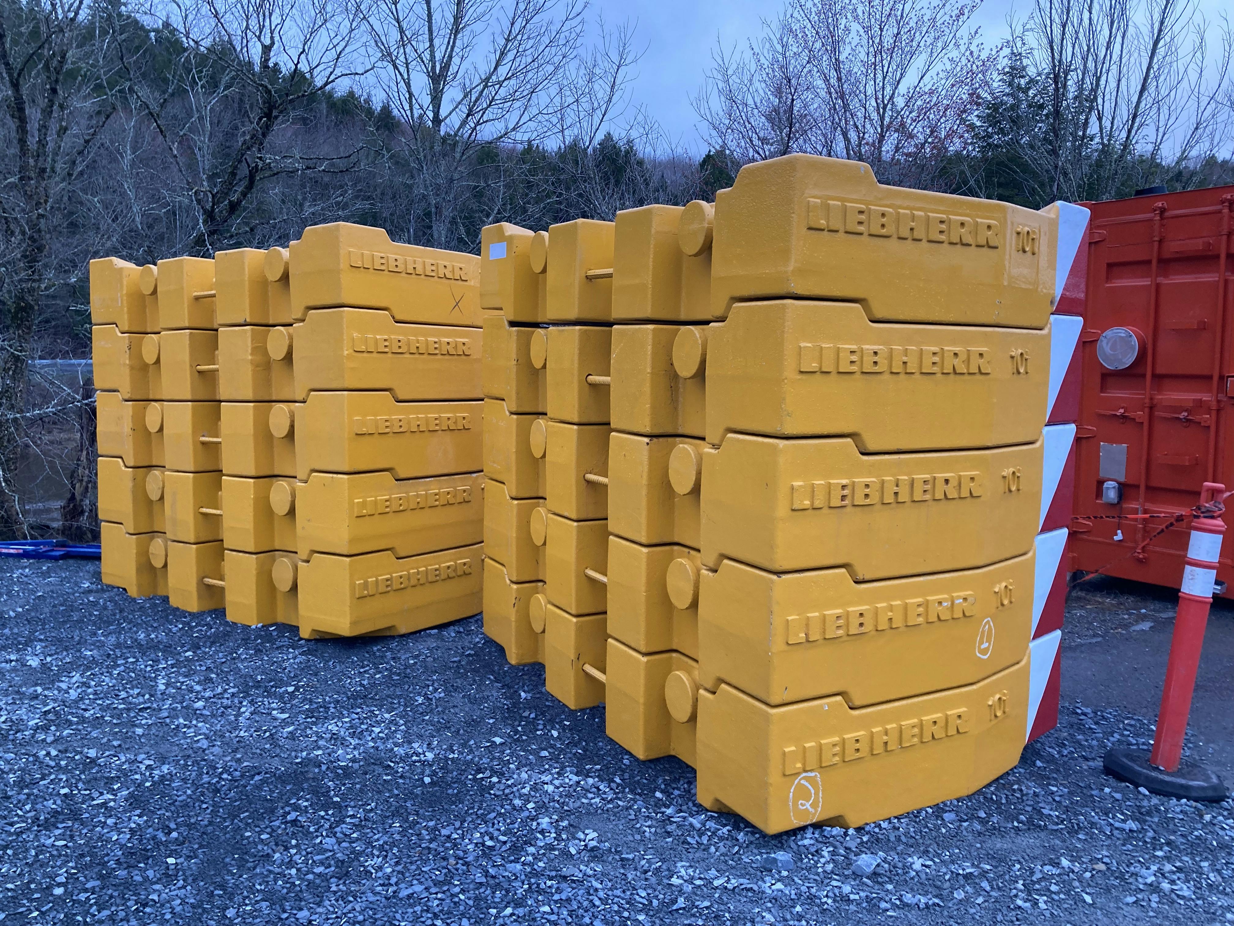 A photo of two racks of ten tonne weights