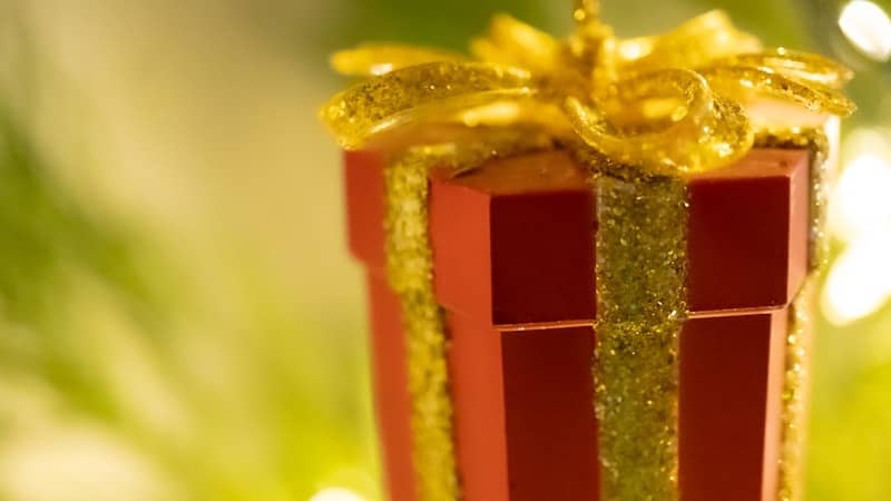 A red gift box with a gold bow