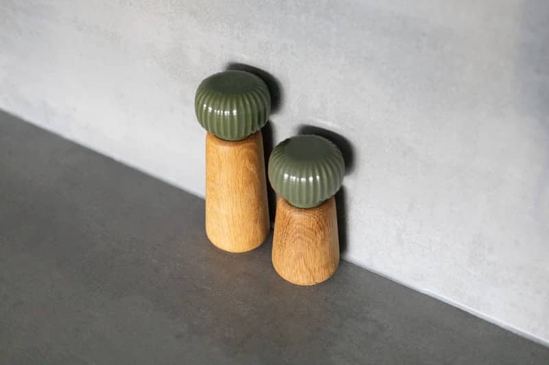 A couple of green knobs sitting on top of a counter
