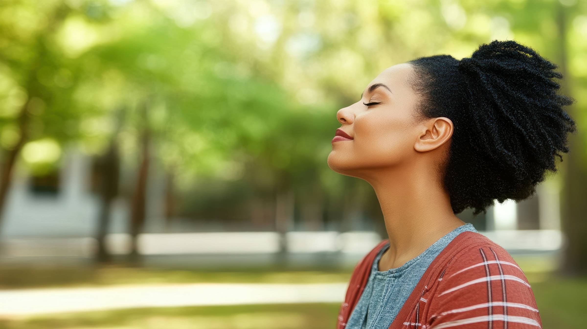 A mum with ADHD taking a deep breath in the outdoors to calm her nervous system