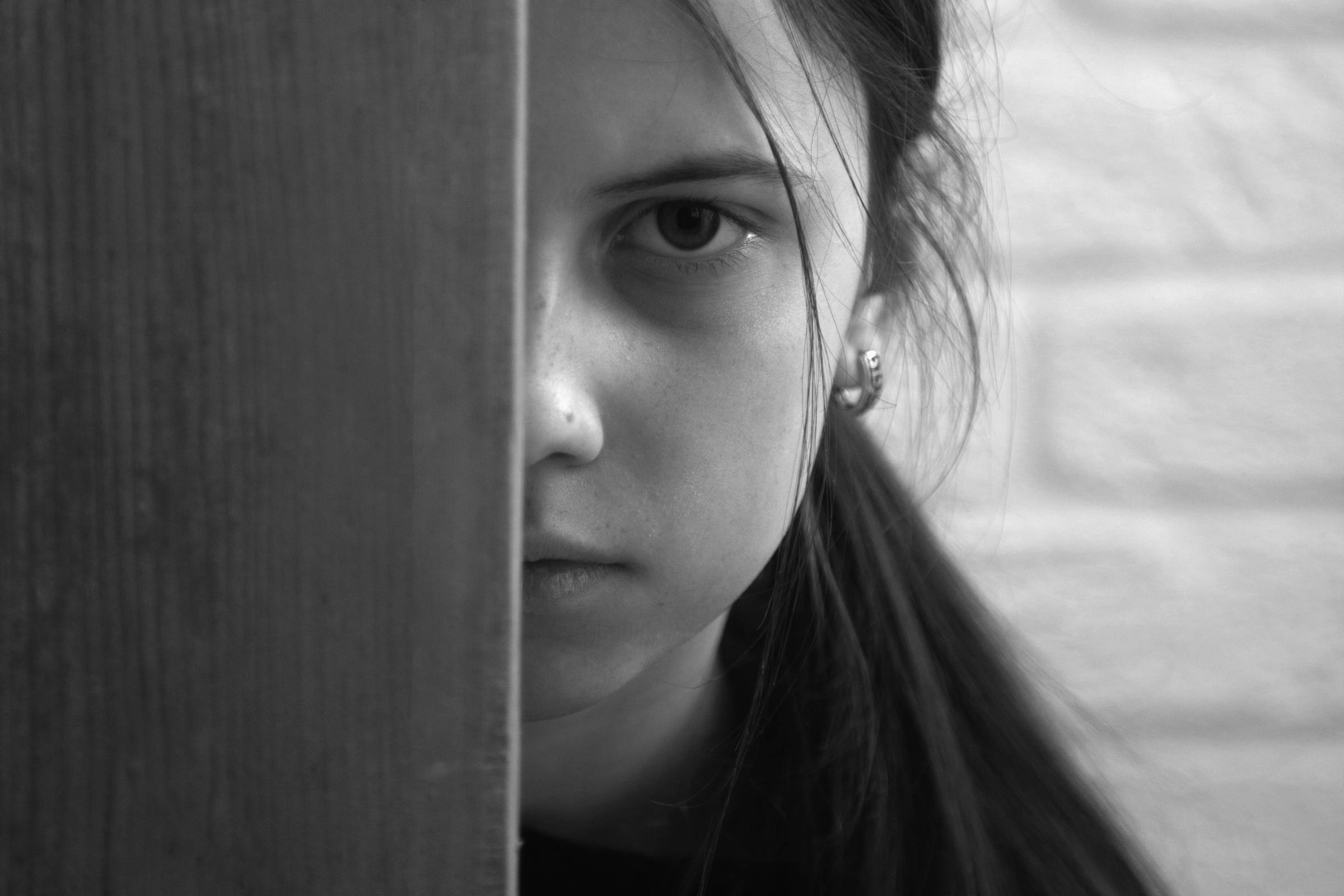 A teenage girl hiding half her face