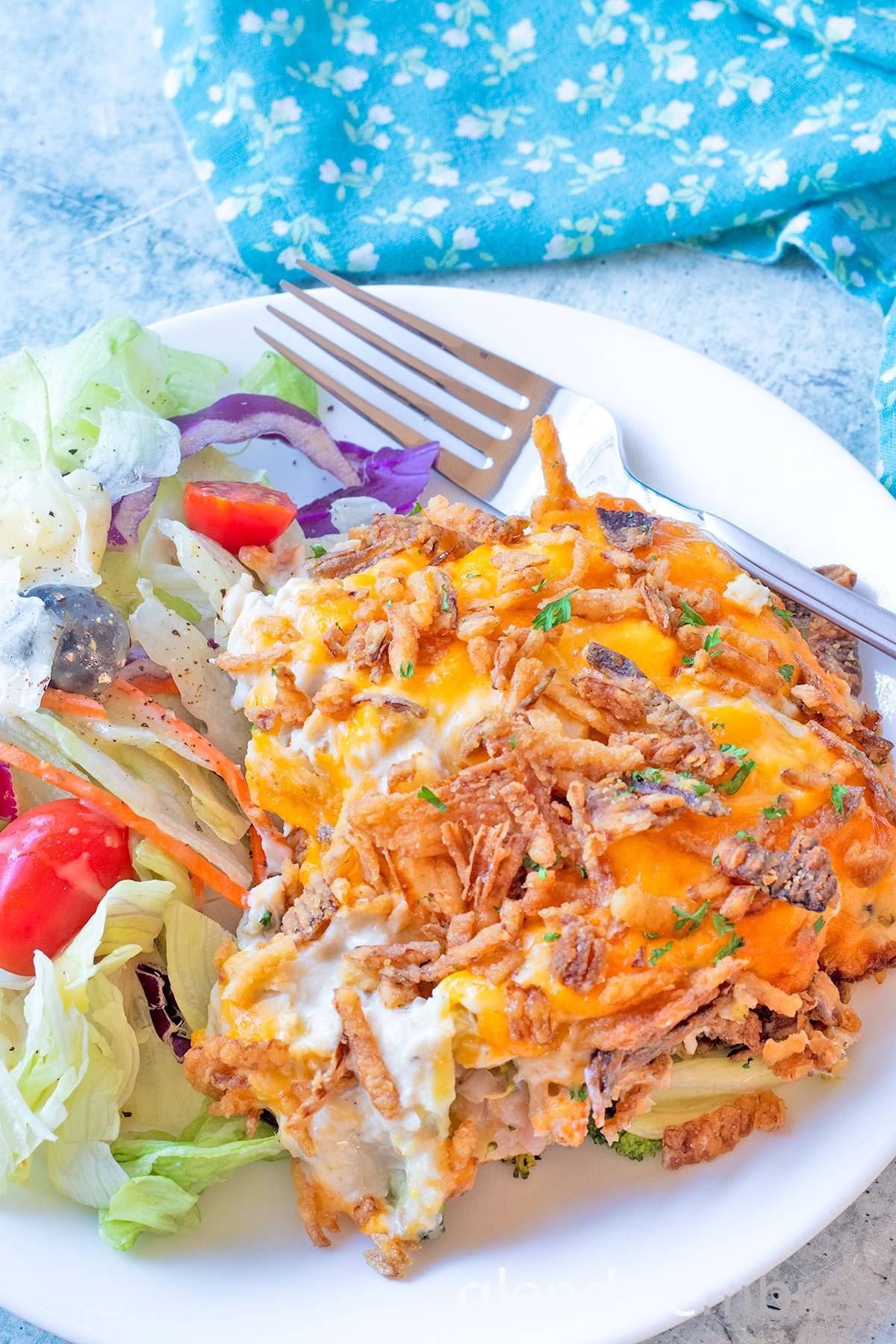 Chicken Casserole on a white plate with House Salad.