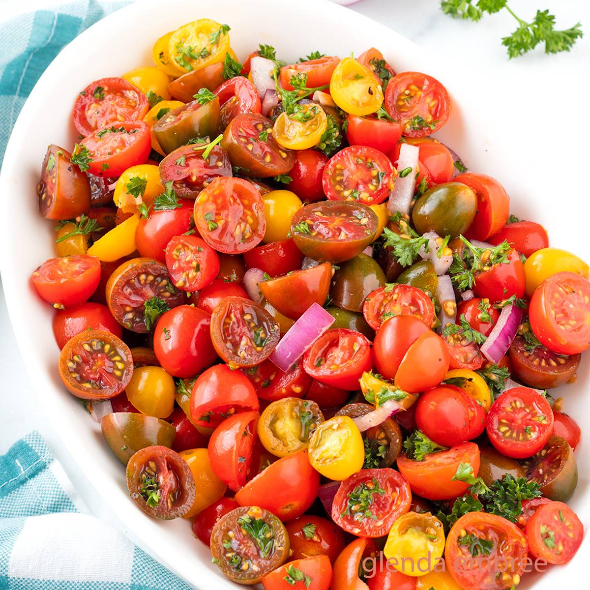 Tomato Salad in a white oval serving bowl.