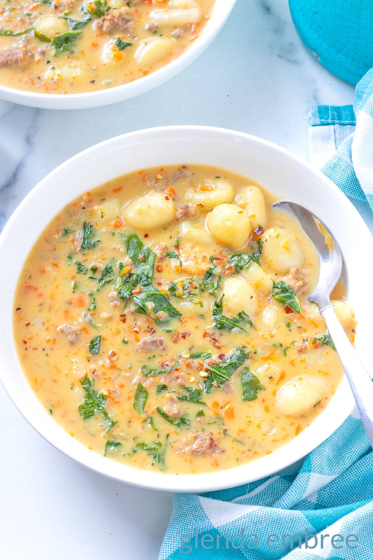 Creamy Sausage and Gnocchi Soup in a white ceramic bowl.
