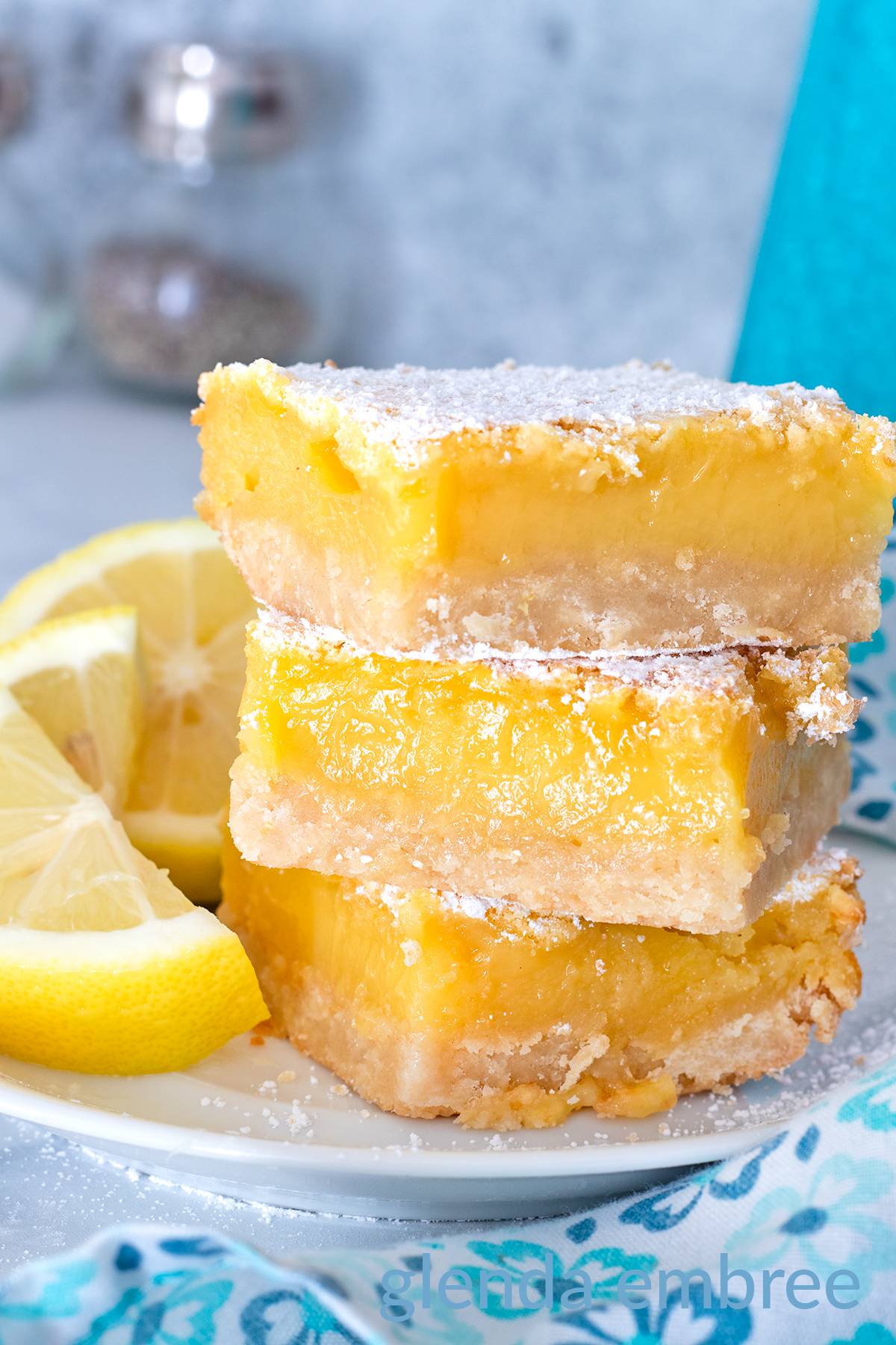 Lemon Bars stacked on a white plate.
