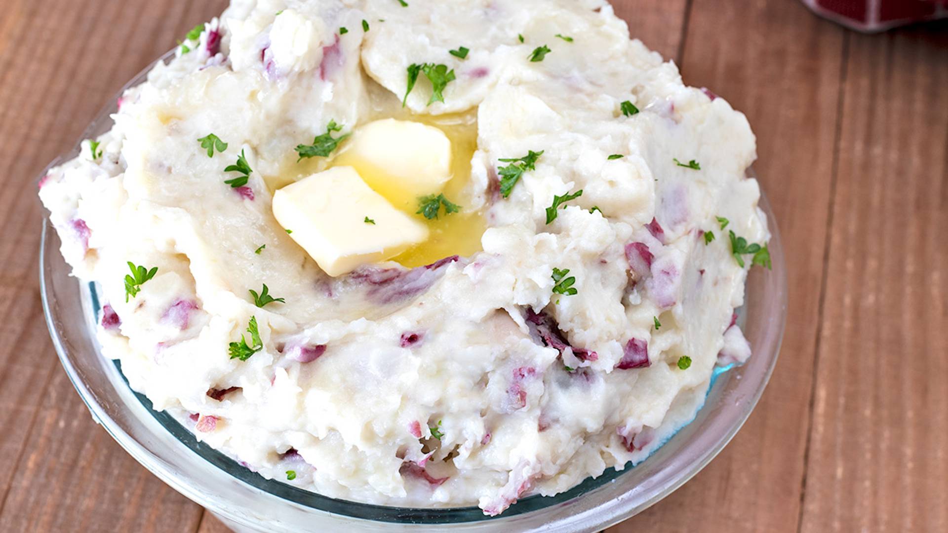 Red Skin Mashed Potatoes in a clear bowl.