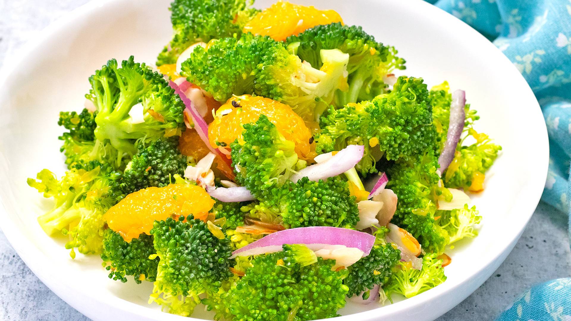 Crunchy Broccoli Salad with Grapefruit Vinaigrette in a white bowl.