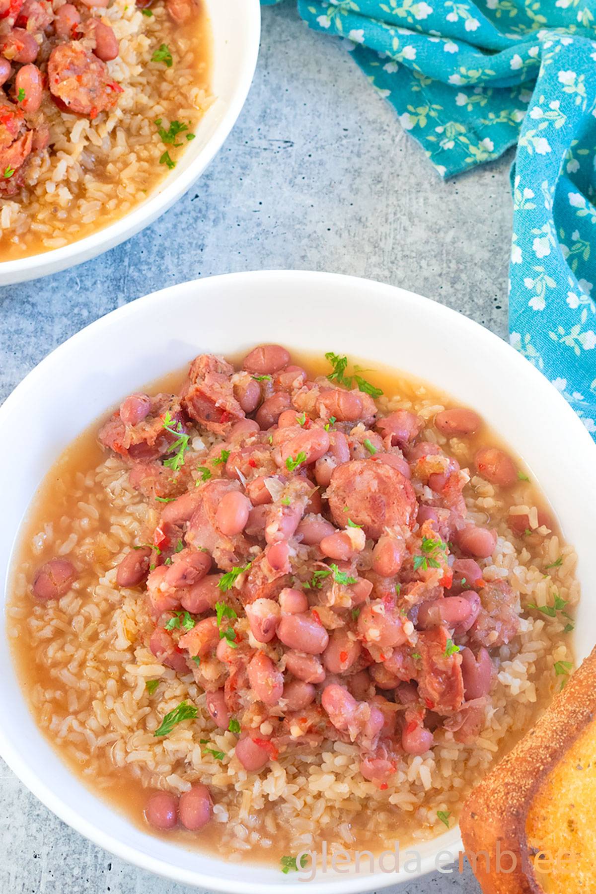 Red Beans and Rice in a white ceramic bowl, with garlic toast on the side.