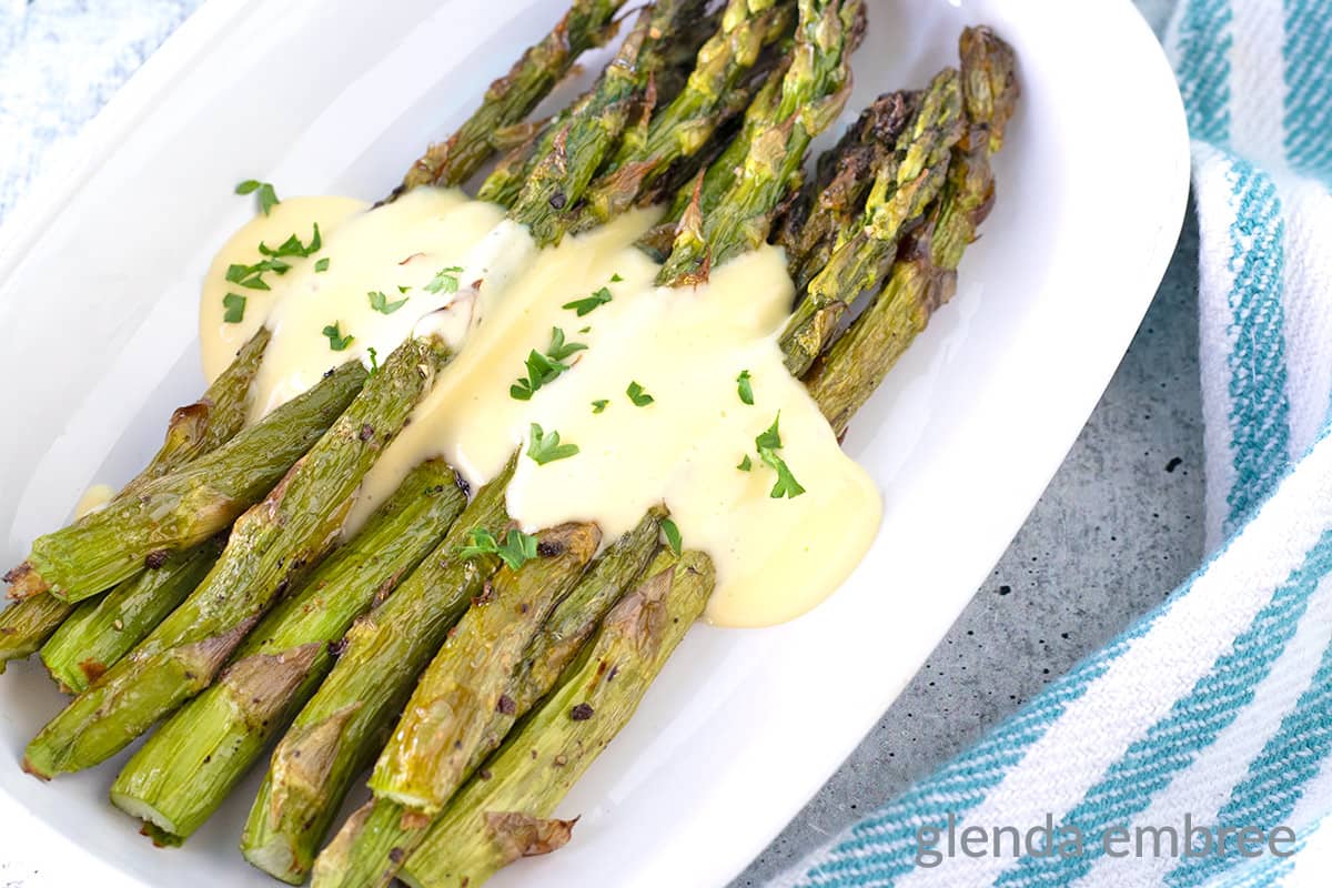Air Fryer Asparagus on a white plate.