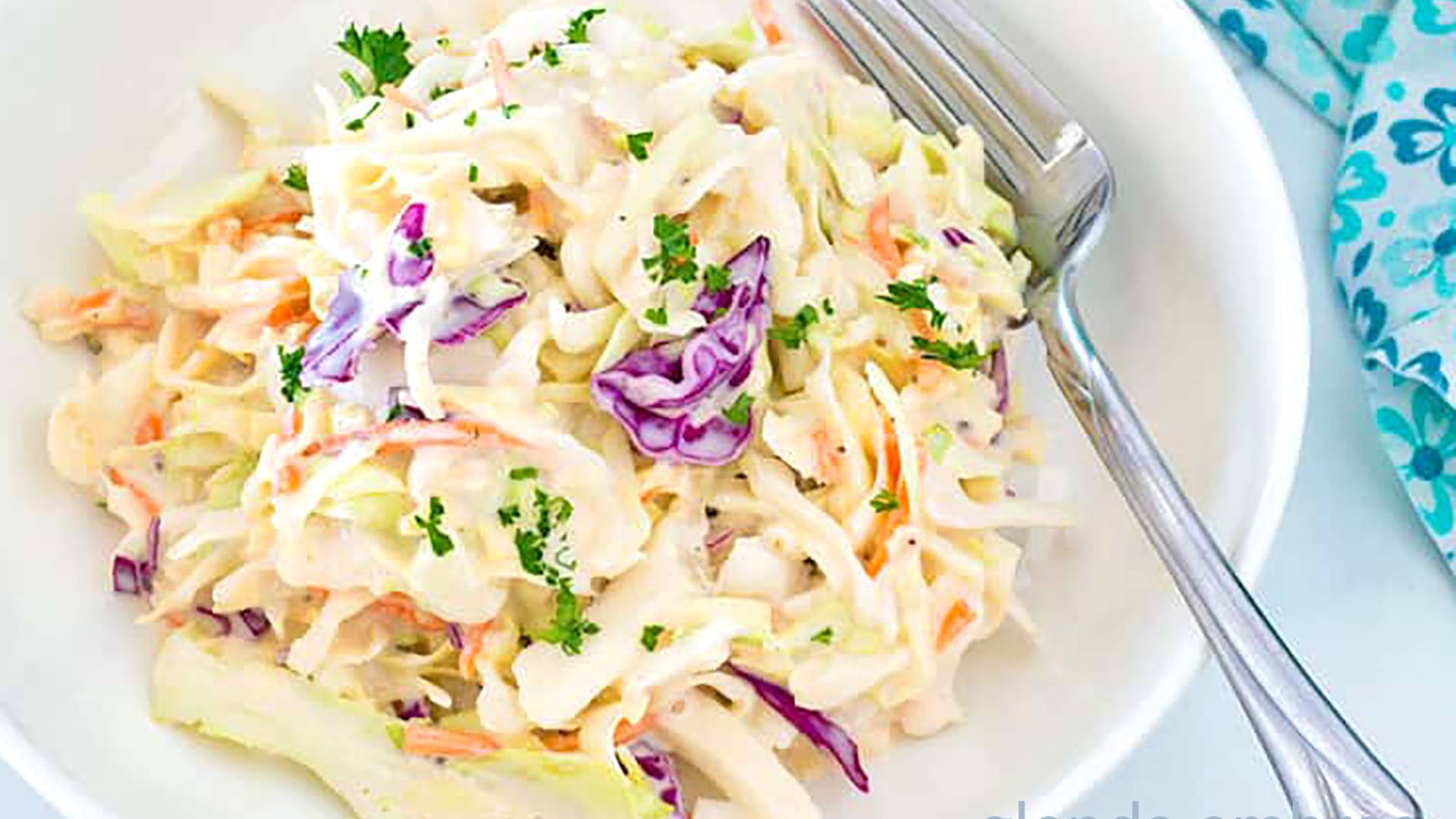 Creamy Coleslaw on a white plate.