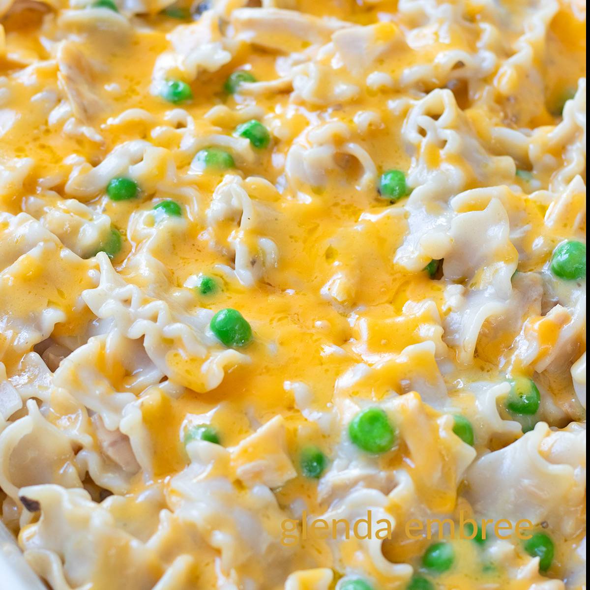 Close-up of tuna casserole with cream of mushroom soup in a white ceramic baker.