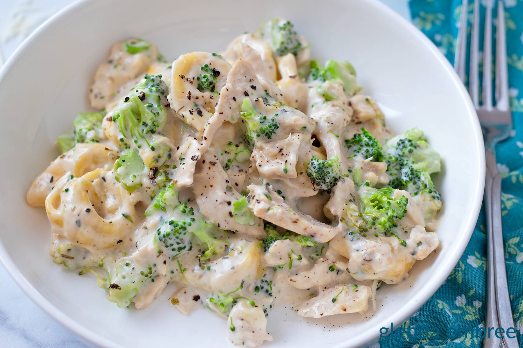 Easy Chicken Tortellini with Broccoli in a white low-sided bowl.