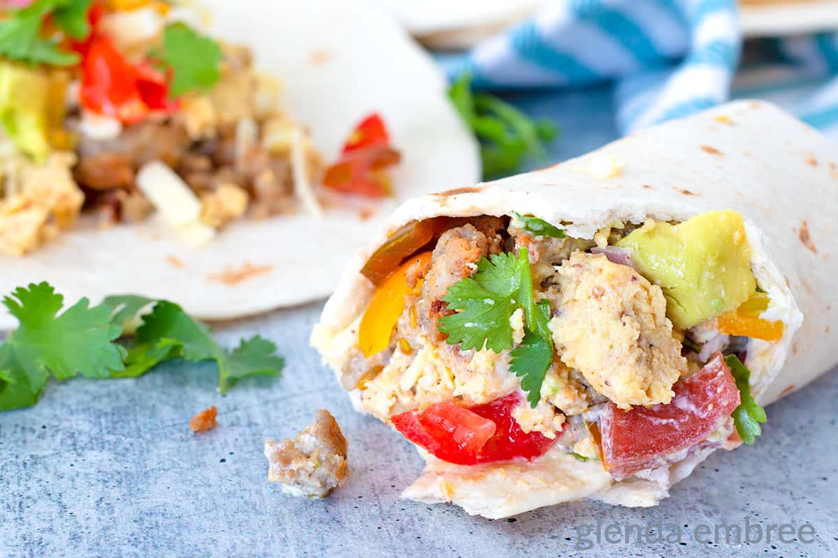 Breakfast Tacos being assembled on a concrete countertop.