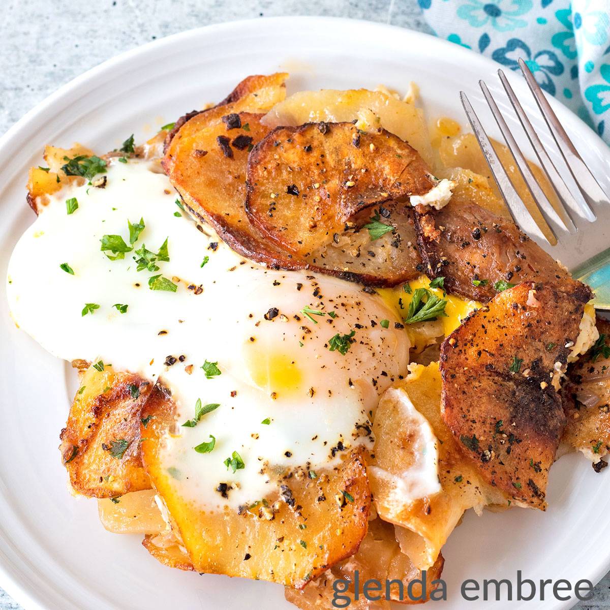 Oven Fried Potatoes and Onions with a Soft-cooked egg on top.