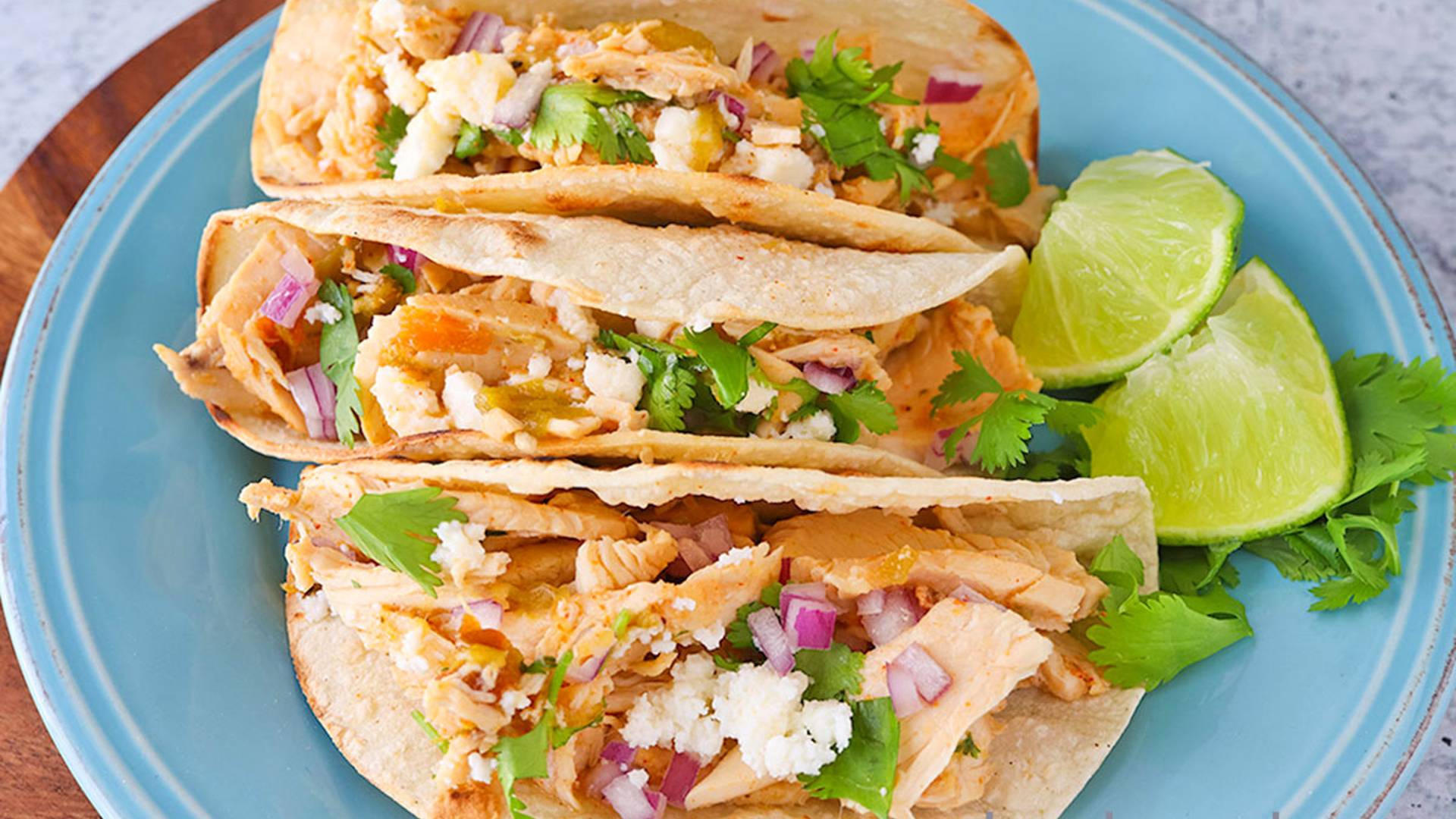 Chicken Street Tacos on a blue stoneware plate.