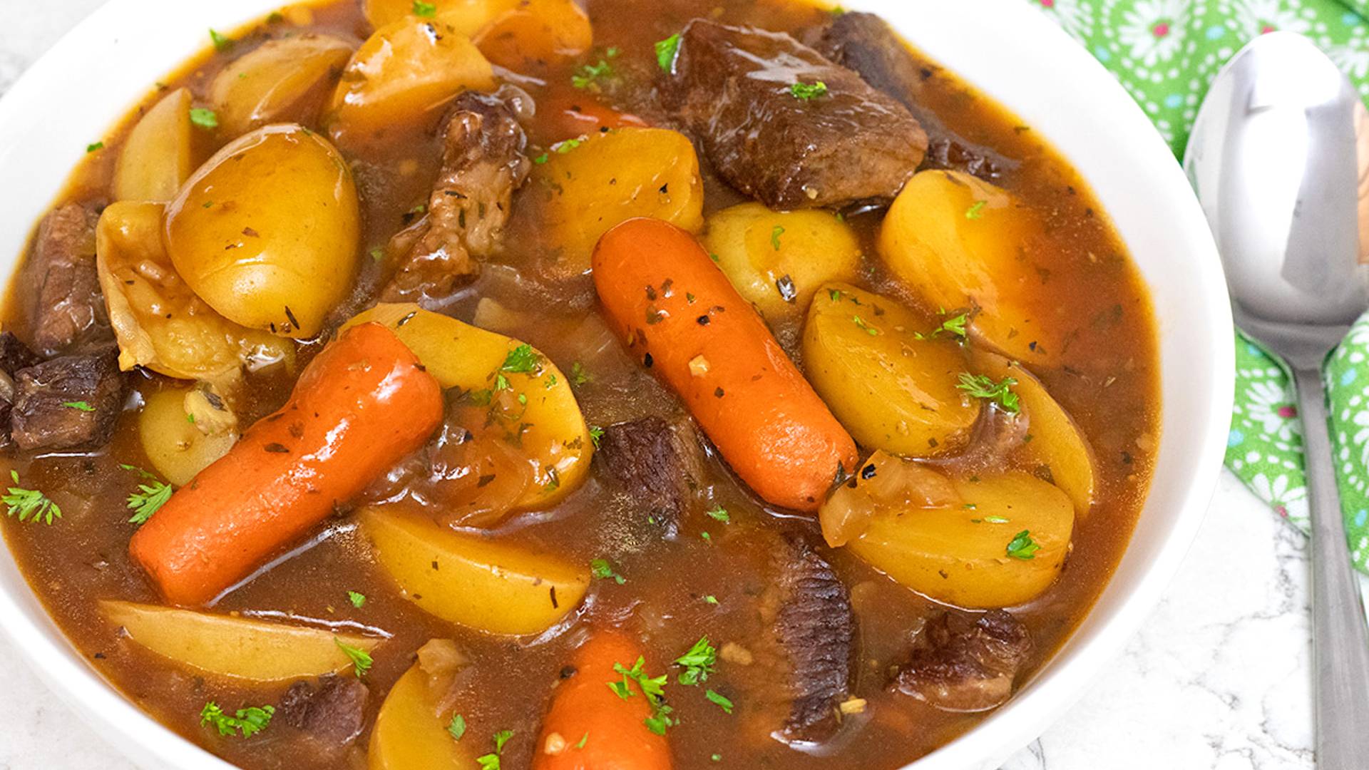 Slow Cooker Beef Stew served in a white ceramic bowl.