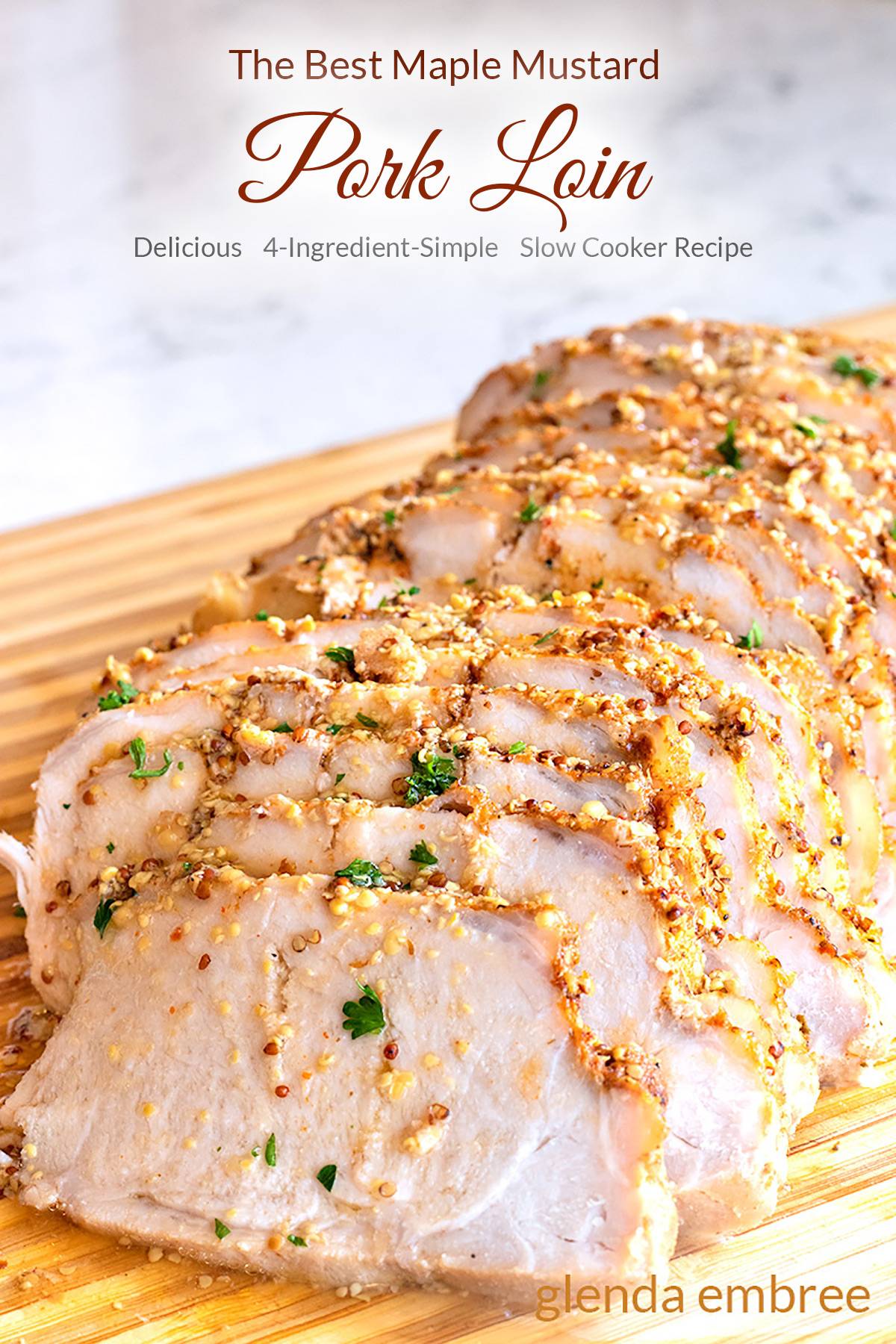 Maple Mustard Pork Loin sliced and resting on a wooden cutting board.