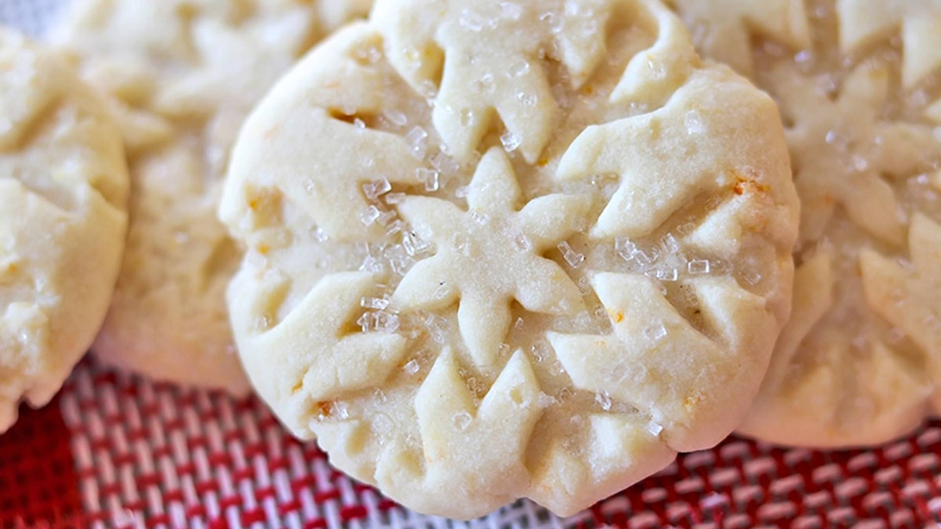 Orange Shortbread cookies on red and white holiday burlap.