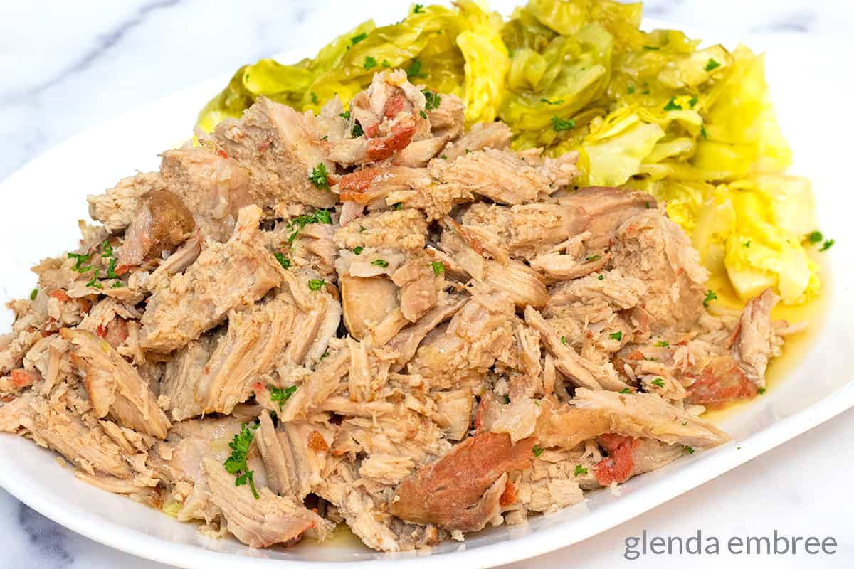 Kalua Pork and Cabbage on a white platter.