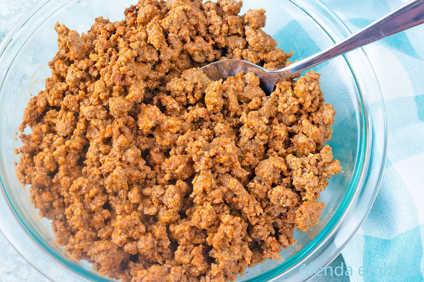 Easy Ground Beef Taco Meat in a clear glass bowl on a concrete countertop.