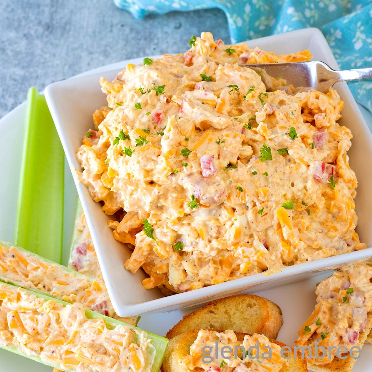Old FAshioned Pimento Cheese on a platter with celery sticks and crackers.